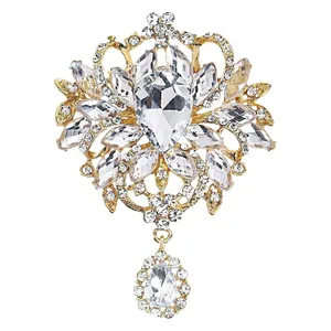 Vintage gold-tone alloy brooch with large pear-shaped crystals and rhinestones