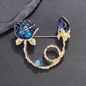 Elegant blue rose brooch pin with gold-tone alloy branch and blue crystal gemstone
