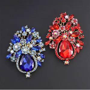 Detailed macro view of heavy-duty crystal glass flower basket brooches in red and blue