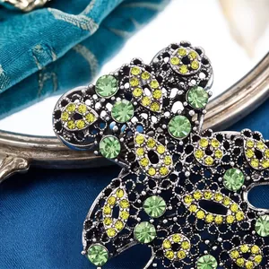 Exquisite hollow teddy bear brooch with green and yellow rhinestones macro detail