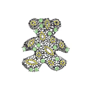 Vintage hollow-out teddy bear brooch with green and yellow sparkling rhinestones.