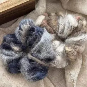 Macro shot of fuzzy plush scrunchies in blue and beige with soft mohair texture