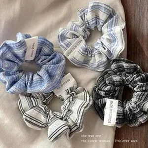 Detailed view of vintage striped cotton scrunchies hair ties with handmade labels