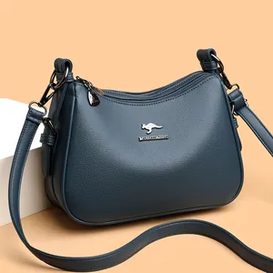 Vintage navy blue soft leather crossbody bag with minimalist kangaroo logo detail.