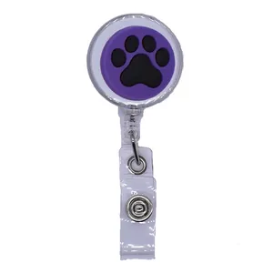 Detailed view of a purple retractable ID badge reel featuring a black cat paw print