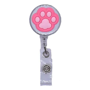 Close-up detail of the pink cartoon cat paw retractable badge reel and ID holder clip.