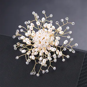 Detailed view of handmade snowflake brooch with elegant imitation pearls and crystals