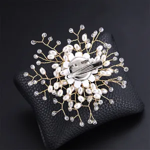 Detailed back view of handmade faux pearl snowflake brooch with silver pin fastener