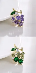 Macro view of exquisite grape-shaped brooches featuring purple and green zircon crystals