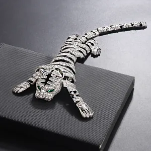 Macro shot of a long articulated tiger brooch featuring sparkling rhinestones and black enamel stripes