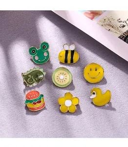 Detail of various colorful enamel pins including cute cartoon animals and food shapes