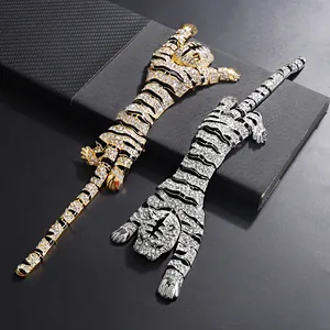 Close-up of gold and silver tiger brooches with sparkling rhinestones and enamel.