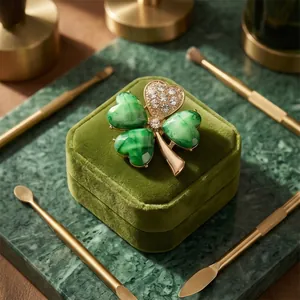 Elegant green and gold four-leaf clover brooch with crystal inlay on velvet box