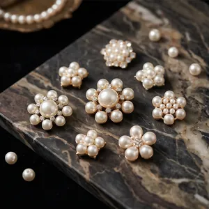 Set of elegant flower-shaped pearl brooches on a marble display base