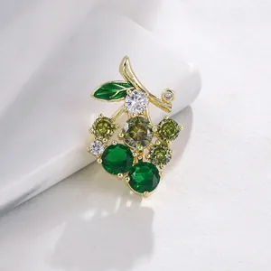 Elegant green crystal grape cluster brooch with sparkling cubic zirconia in gold plating.