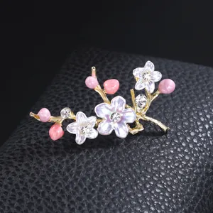 Elegant vintage floral brooch with pink buds and clear rhinestones on black leather base