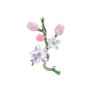 Elegant vintage enamel flower brooch featuring pink buds and sparkling rhinestones