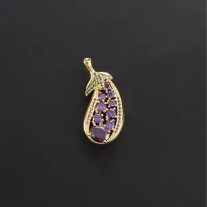 Elegant eggplant-shaped gold brooch featuring vibrant purple and green sparkling crystals