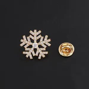Elegant mini zircon snowflake brooch with gold-toned finish on black background