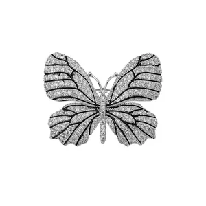 Elegant butterfly brooch with sparkling crystals and black enamel detailing on white backdrop