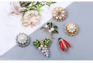 Collection of elegant pearl and rhinestone brooches with various nature motifs