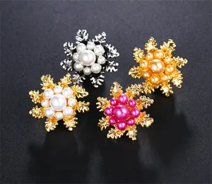 Close-up detail showing multi-colored camellia pearl brooches for elegant clothing