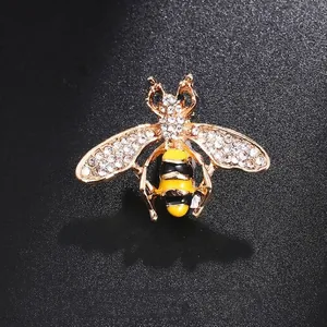 Cute gold-toned bee brooch pin with sparkling rhinestones and yellow black enamel stripes