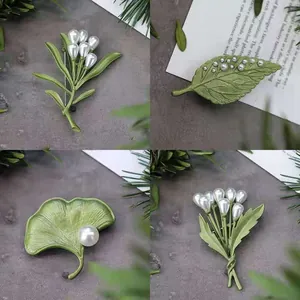 Vintage baroque pearl leaf brooch set with green enamel finish and floral designs