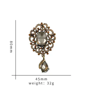 Detail of vintage bronze brooch showing grey crystal stones and dimensions