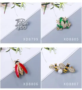 Collection of four elegant rhinestone brooches featuring frog, bee, and beetle designs