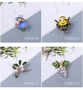 Selection of stylish brooches including cartoon characters and elegant pearl designs.
