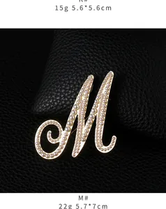 Elegant large letter M brooch featuring white pearls and high-shine gold finish