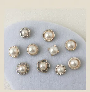 Detailed macro view of various decorative faux pearl pins with gold-tone borders