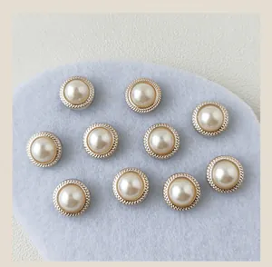 Detailed view of ten elegant gold-rimmed pearl buttons on a soft blue background