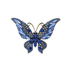 Elegant butterfly brooch with sparkling blue crystals in a vintage gold-tone finish