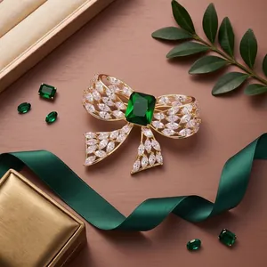 Elegant gold-tone bow brooch featuring a large green emerald-cut zircon and clear crystals