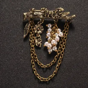 Vintage golden branch brooch with pearl cluster and layered chains for suits