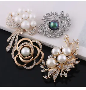 Close-up of elegant pearl and rhinestone brooches with floral and bow designs.