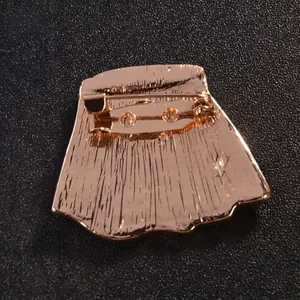 Back view of elegant gold-toned rhinestone brooch with secure safety pin closure