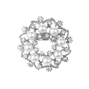 Elegant circular pearl and rhinestone floral brooch pin in silver finish