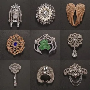Vintage crystal brooch set featuring angel wings and pearl flower designs for elegant coats