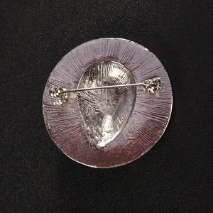 High-quality back view of silver vintage wing brooch pin with safety fastener mechanism