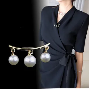 Elegant gold curved brooch pin with dangling white pearls for suits and dresses