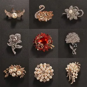 Elegant set of nine crystal and pearl brooches with flower and swan designs for clothing
