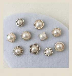 Detailed view of assorted elegant pearl buttons and brooches with gold metal frames