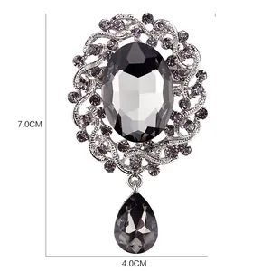 Detailed size view of a vintage style grey crystal drop brooch for suit and coat lapels.