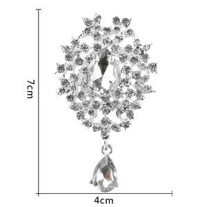 Macro view of teardrop crystal brooch detailing dimensions of 7cm height and 4cm width