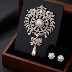 Elegant vintage crystal brooch and pearl earrings set featuring a large water drop pendant