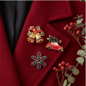 Close-up of festive Christmas brooches with rhinestone snowflake and car on coat