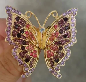 Close-up detail of an elegant butterfly brooch with colorful sparkling rhinestones